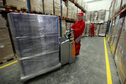 Warehousing - Two workers working in storehouse